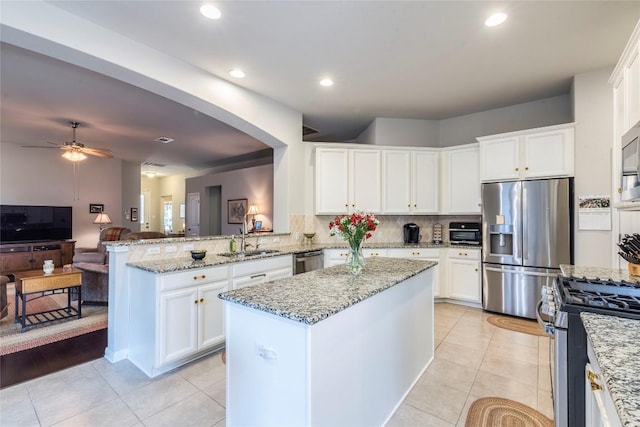 351 Still Hollow Crk, Buda, TX 78610 - kitchen featuring stainless steel appliances, a sink, white cabinetry, decorative backsplash, and recessed lighting