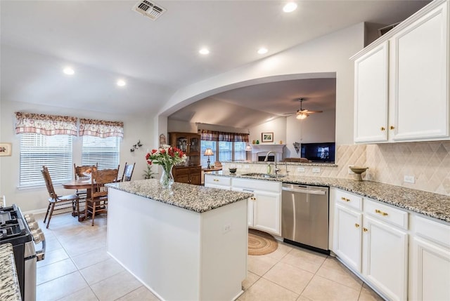 351 Still Hollow Crk, Buda, TX 78610 - kitchen featuring appliances with stainless steel finishes, lofted ceiling, a sink, a ceiling fan, and light tile patterned floors
