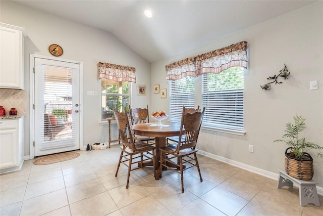 351 Still Hollow Crk, Buda, TX 78610 - dining room with plenty of natural light, vaulted ceiling, light tile patterned floors, and baseboards