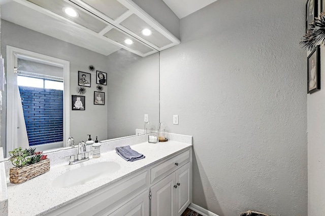 409 Hurst Creek Rd, Lakeway, TX 78734 - bathroom featuring vanity, a textured wall, and recessed lighting