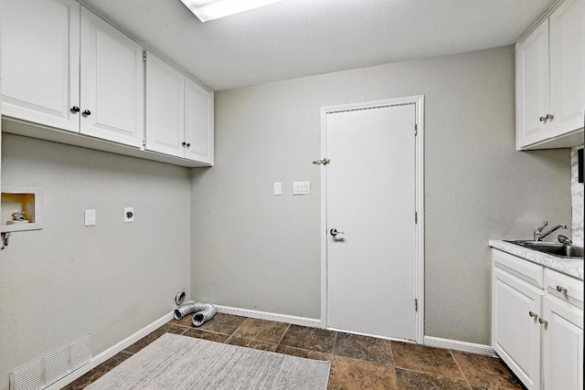 409 Hurst Creek Rd, Lakeway, TX 78734 - laundry room featuring hookup for an electric dryer, baseboards, cabinet space, washer hookup, and dark stone finish flooring