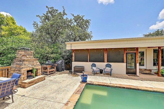 409 Hurst Creek Rd, Lakeway, TX 78734 - view of patio / terrace with an outdoor stone fireplace, a grill, and an outdoor pool