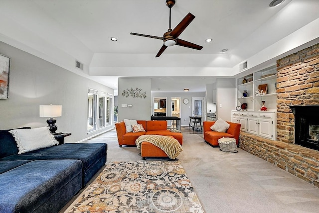 409 Hurst Creek Rd, Lakeway, TX 78734 - living area featuring light carpet, ceiling fan, a stone fireplace, recessed lighting, and built in features