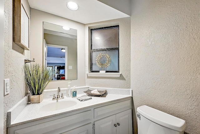 409 Hurst Creek Rd, Lakeway, TX 78734 - bathroom featuring a textured wall, vanity, and toilet