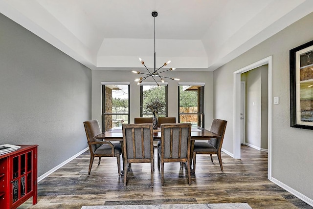 409 Hurst Creek Rd, Lakeway, TX 78734 - dining area with a tray ceiling, a chandelier, dark wood-type flooring, baseboards, and a textured wall