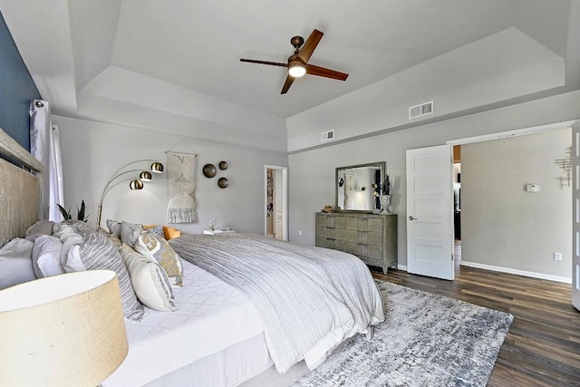 409 Hurst Creek Rd, Lakeway, TX 78734 - bedroom with a raised ceiling, wood finished floors, baseboards, and ceiling fan