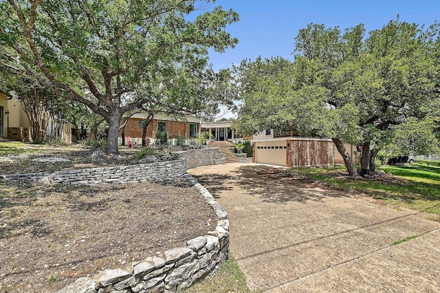 409 Hurst Creek Rd, Lakeway, TX 78734 - view of front of home with driveway, an attached garage, and brick siding