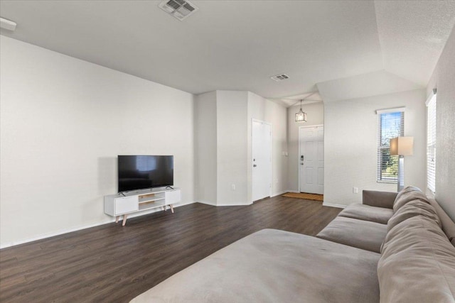living room with baseboards, visible vents, and dark wood-type flooring