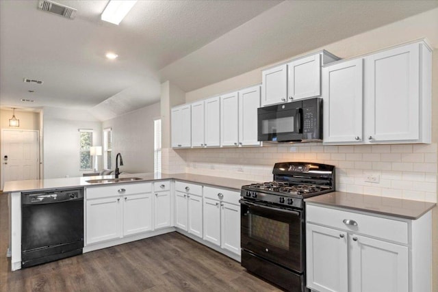 kitchen with tasteful backsplash, a sink, black appliances, visible vents, and dark wood-style floors