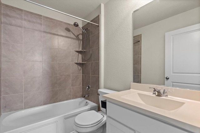 bathroom with shower / bath combination, a textured wall, toilet, and vanity
