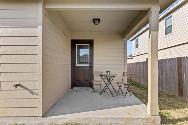 entrance to property featuring fence