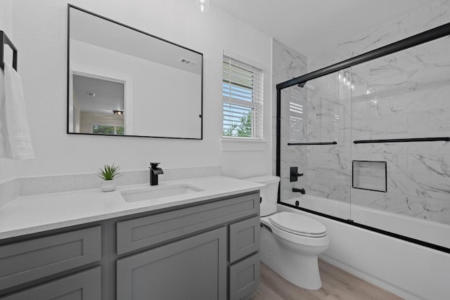 3005 Canter Ln, Austin, TX 78759 - full bath with vanity, enclosed tub / shower combo, and wood finished floors