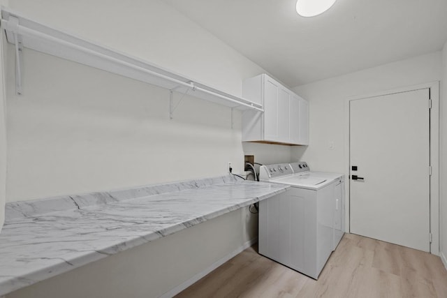 3005 Canter Ln, Austin, TX 78759 - laundry room featuring light wood-type flooring, washer and dryer, and cabinet space