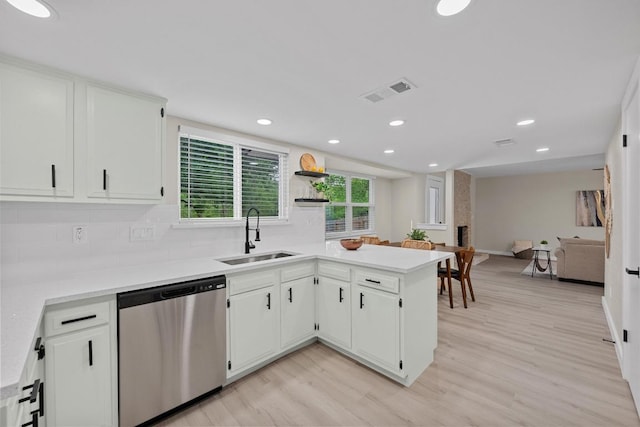 3005 Canter Ln, Austin, TX 78759 - kitchen with stainless steel dishwasher, light wood-style floors, recessed lighting, light countertops, and white cabinetry