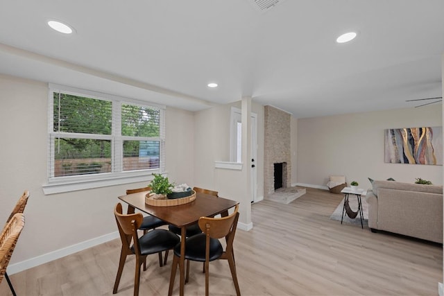 3005 Canter Ln, Austin, TX 78759 - dining space with baseboards, a fireplace, light wood finished floors, and recessed lighting