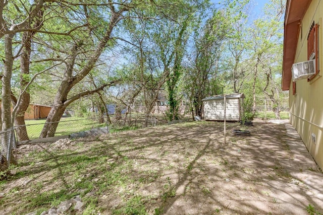 view of yard with a fenced backyard, an outdoor structure, and a shed
