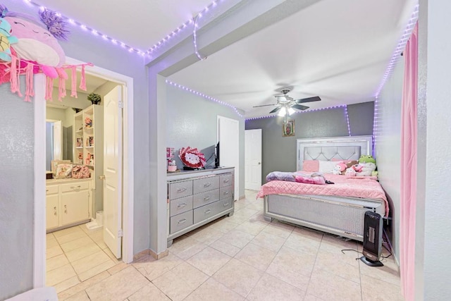 bedroom with light tile patterned floors, ceiling fan, and ensuite bathroom
