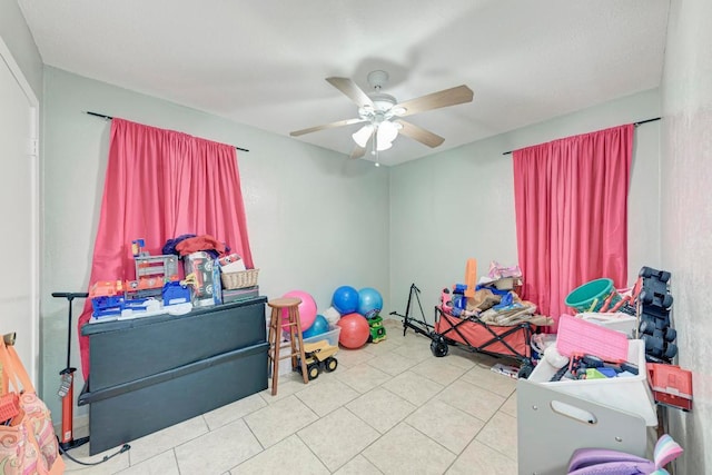 recreation room featuring a ceiling fan and light tile patterned flooring