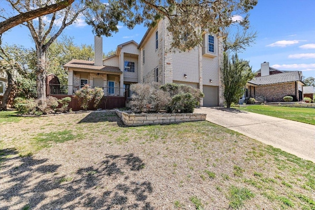 7304 Halbert Dr, Austin, TX 78750 - view of front facade featuring a garage, concrete driveway, a front lawn, and a chimney