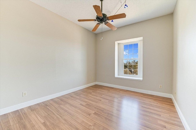 7304 Halbert Dr, Austin, TX 78750 - spare room featuring light wood-style flooring, ceiling fan, baseboards, and a textured ceiling