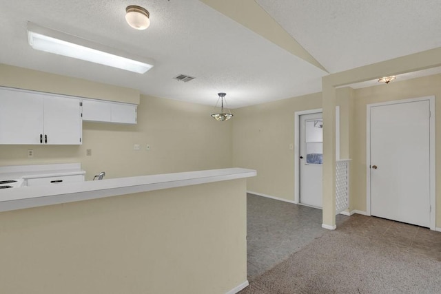 36 Oak Villa Dr # C-2, Canyon Lake, TX 78133 - interior space with visible vents, baseboards, white cabinetry, light countertops, and hanging light fixtures