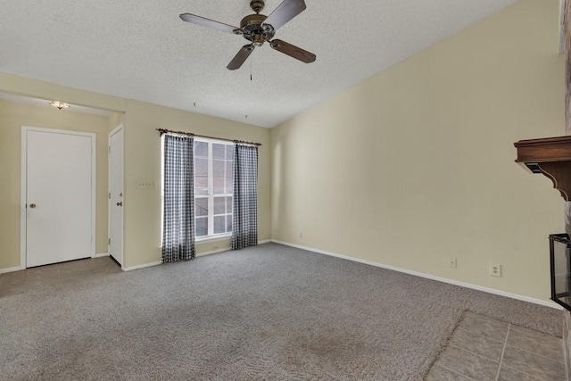 36 Oak Villa Dr # C-2, Canyon Lake, TX 78133 - unfurnished living room featuring baseboards, a ceiling fan, carpet flooring, and a textured ceiling