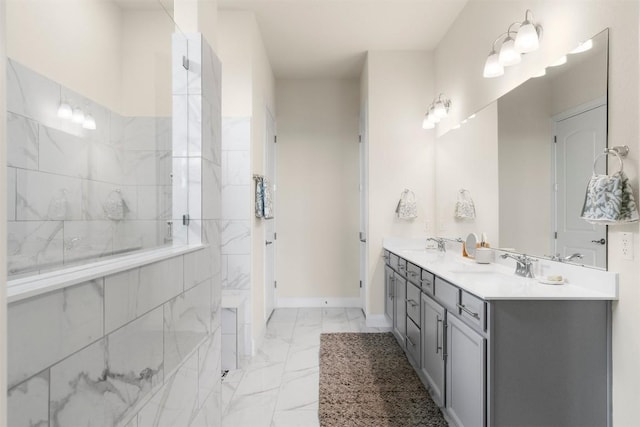 195 Barn Hill Loop, Dripping Springs, TX 78620 - bathroom featuring marble finish floors, double vanity, baseboards, and a shower