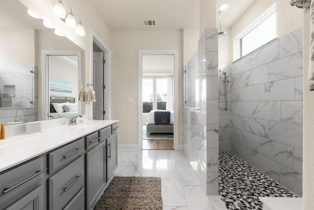 195 Barn Hill Loop, Dripping Springs, TX 78620 - ensuite bathroom with vanity, a marble finish shower, and marble finish flooring