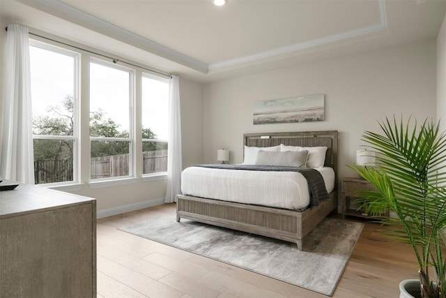 195 Barn Hill Loop, Dripping Springs, TX 78620 - bedroom featuring multiple windows, a tray ceiling, light wood-type flooring, baseboards, and recessed lighting