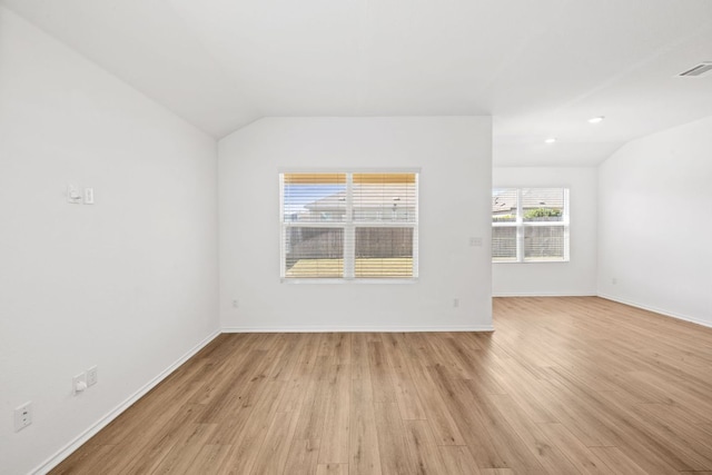 215 Silver Springs Bnd, Kyle, TX 78640 - empty room featuring lofted ceiling, light wood-type flooring, and baseboards