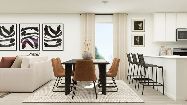 dining area with light wood finished floors and baseboards