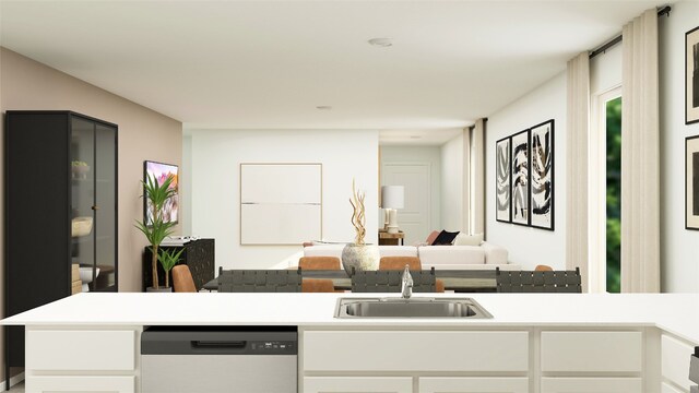 kitchen with light countertops, a sink, dishwasher, open floor plan, and white cabinets