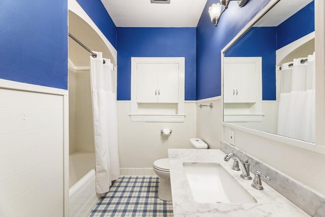 2310 Euclid Ave, Austin, TX 78704 - bathroom with a wainscoted wall, vanity, shower / bath combo with shower curtain, and tile patterned flooring