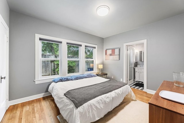 2310 Euclid Ave, Austin, TX 78704 - bedroom with light wood-style floors, baseboards, and connected bathroom