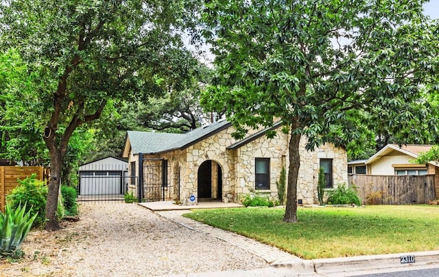 2310 Euclid Ave, Austin, TX 78704 - view of front of home featuring stone siding, an outbuilding, and a detached garage