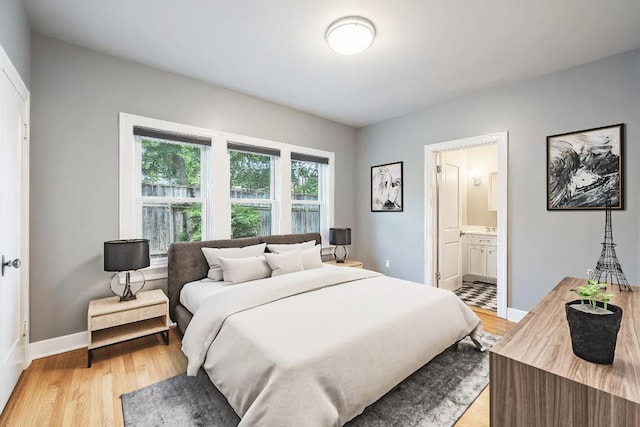 2310 Euclid Ave, Austin, TX 78704 - bedroom with light wood finished floors and ensuite bathroom