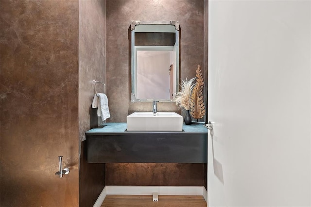 210 Lavaca St Unit 2312, Austin, TX 78701 - bathroom featuring vanity, baseboards, and wood finished floors