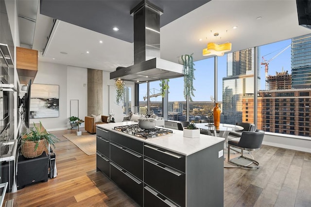 210 Lavaca St Unit 2312, Austin, TX 78701 - kitchen featuring exhaust hood, modern cabinets, dark cabinets, light wood-style flooring, and a city view
