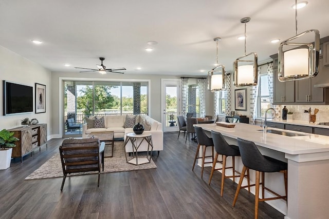 9608 Boathouse Dr, Austin, TX 78744 - living area with dark wood-type flooring, recessed lighting, and a ceiling fan