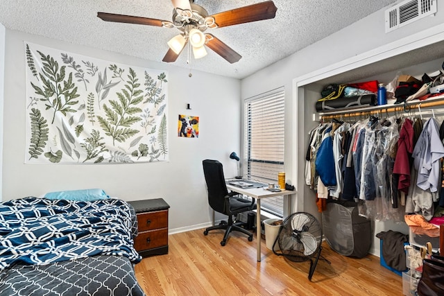 2110 Rio Grande St Unit 207, Austin, TX 78705 - office with a textured ceiling, wood finished floors, a ceiling fan, and baseboards