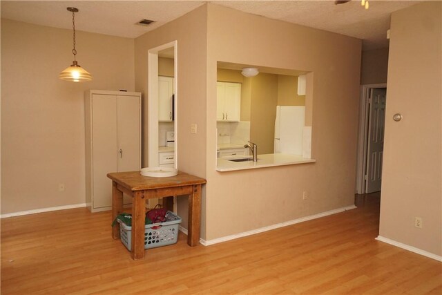 2706 Salado St Unit 210, Austin, TX 78705 - unfurnished living room featuring light wood-type flooring and a sink