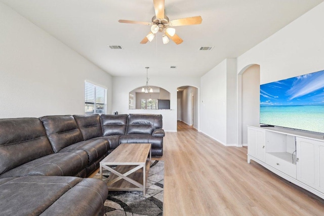 211 Almquist St, Hutto, TX 78634 - living room featuring arched walkways, light wood-style floors, and ceiling fan