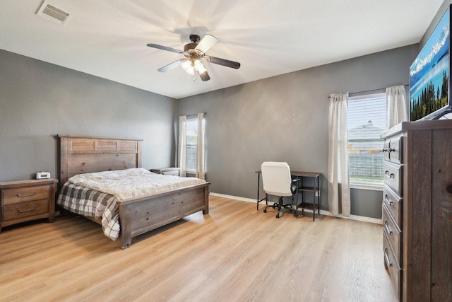211 Almquist St, Hutto, TX 78634 - bedroom with light wood finished floors and ceiling fan