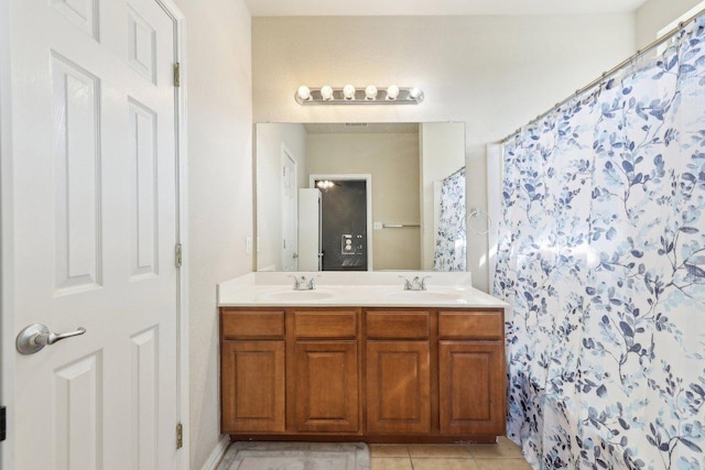 211 Almquist St, Hutto, TX 78634 - bathroom featuring double vanity, tile patterned floors, and curtained shower
