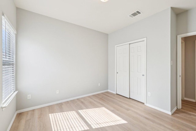 211 Almquist St, Hutto, TX 78634 - unfurnished bedroom featuring light wood-type flooring and a closet