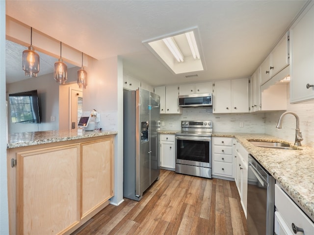 100 Stubblefield Dr, Elgin, TX 78621 - kitchen featuring stainless steel appliances, light wood-type flooring, tasteful backsplash, and light stone countertops