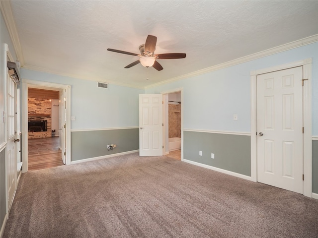 100 Stubblefield Dr, Elgin, TX 78621 - unfurnished bedroom featuring carpet, ornamental molding, connected bathroom, and ceiling fan