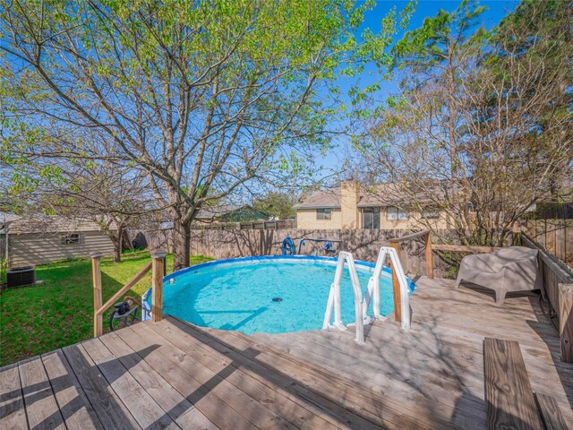 100 Stubblefield Dr, Elgin, TX 78621 - view of pool featuring a deck, a fenced backyard, and an outbuilding