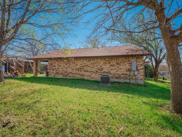 100 Stubblefield Dr, Elgin, TX 78621 - view of home's exterior featuring brick siding, a lawn, stairway, and a shingled roof