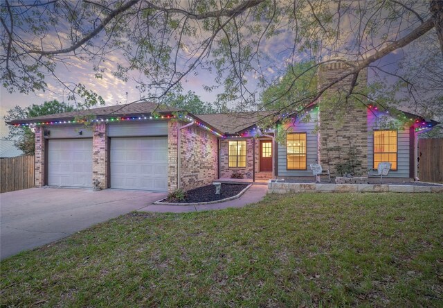 100 Stubblefield Dr, Elgin, TX 78621 - view of front of house featuring concrete driveway, a garage, and brick siding